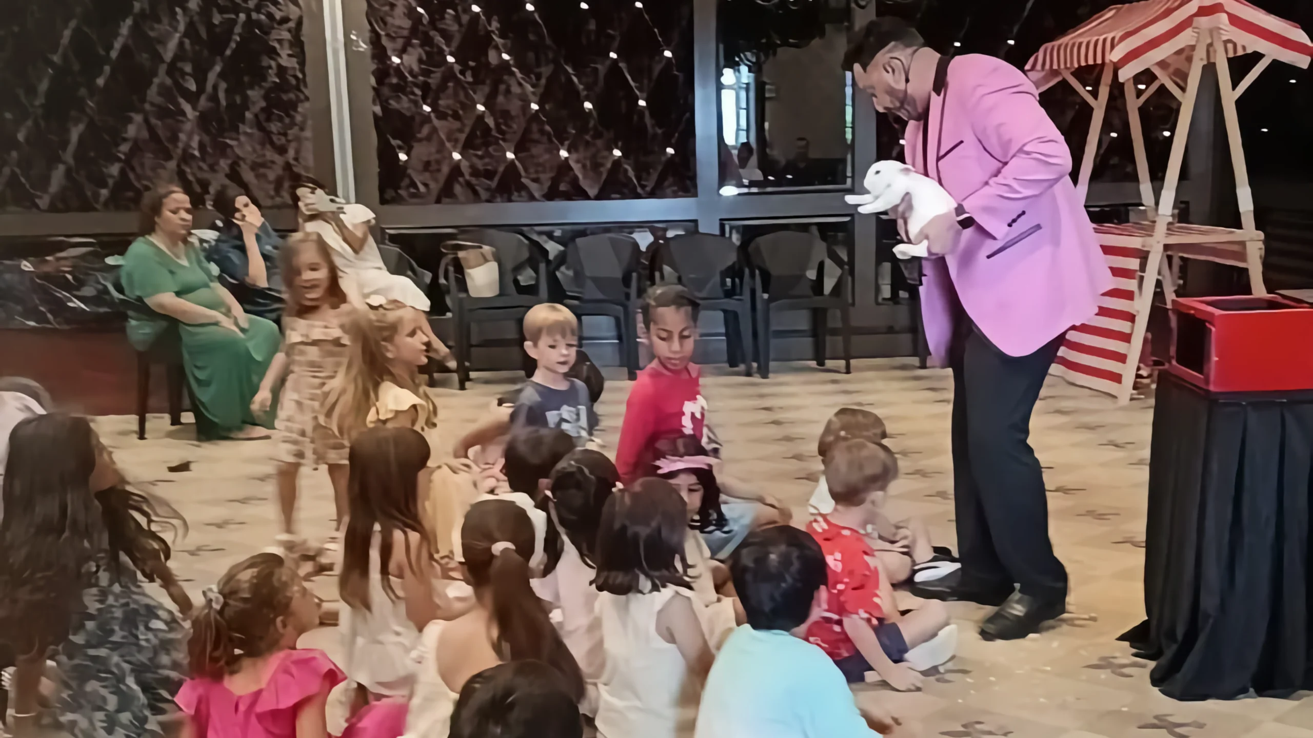 Children watching a magic show with amazement